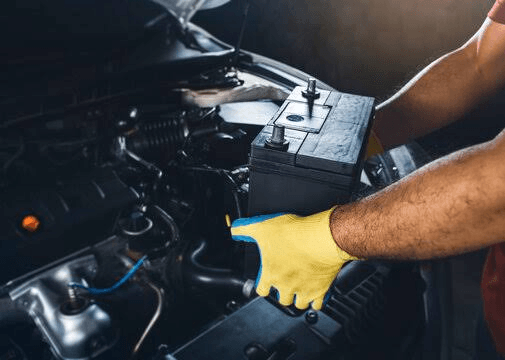 A technician fitting a car battery